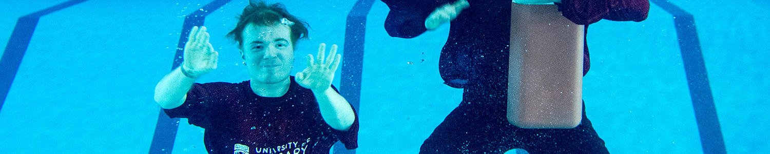 Lifeguard practising an underwater rescue