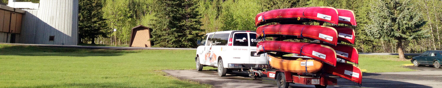Outdoor centre van with canoes in the mountains