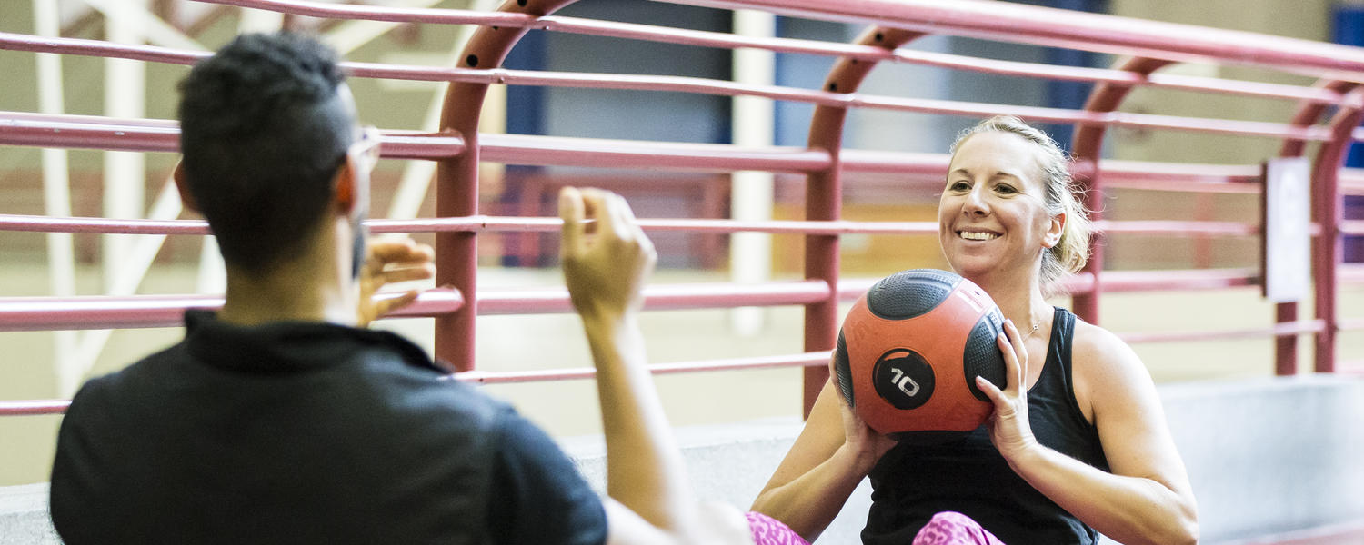Workout partners throw medicine ball