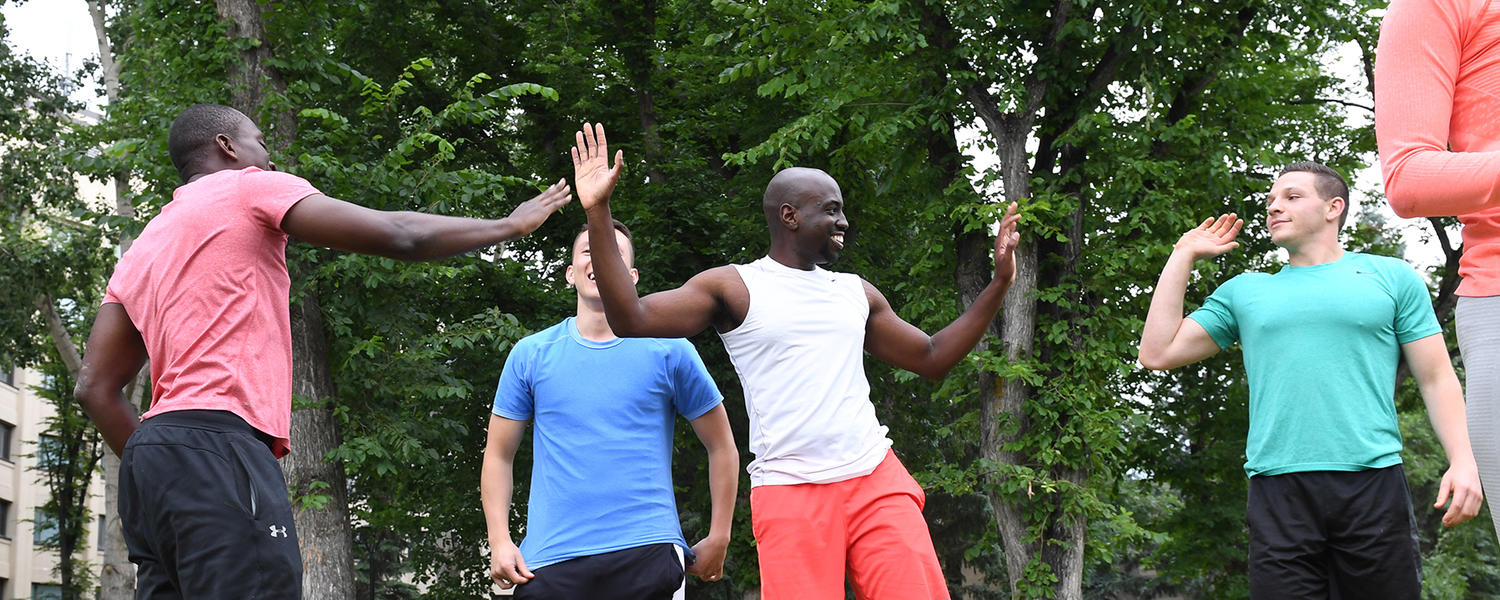 Fitness members high-five after workout
