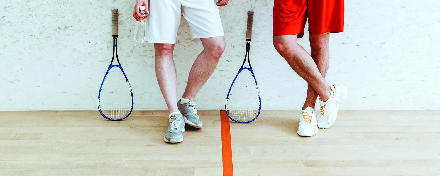 Men in racquet centre