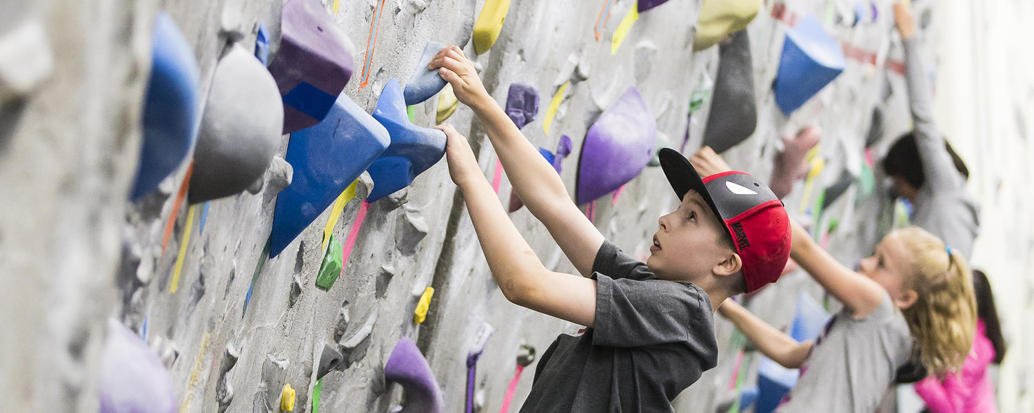 Kids climbing at UCalgary bouldering wall