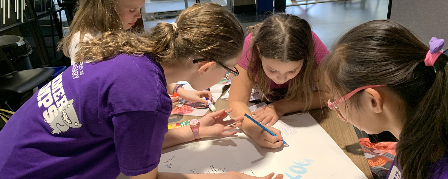 Girls doing a group project at UCalgary Business Camp