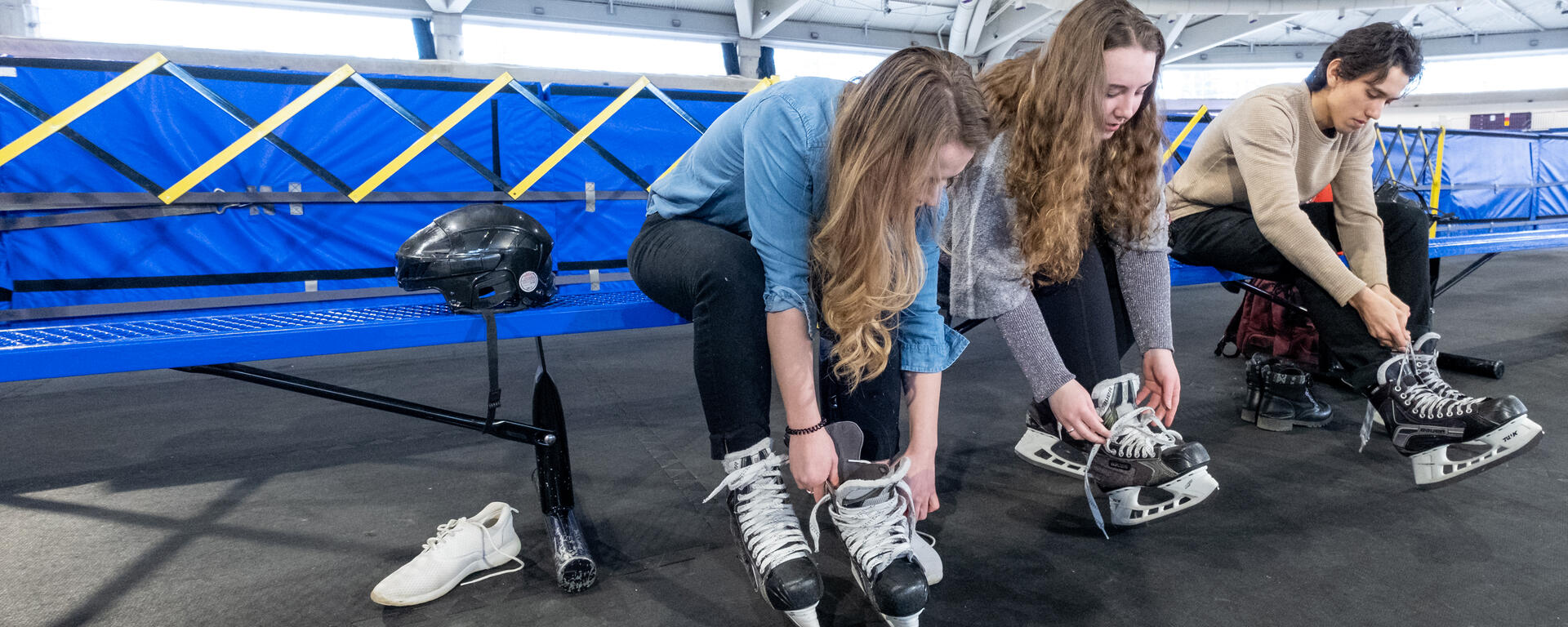 people lacing their ice skates 