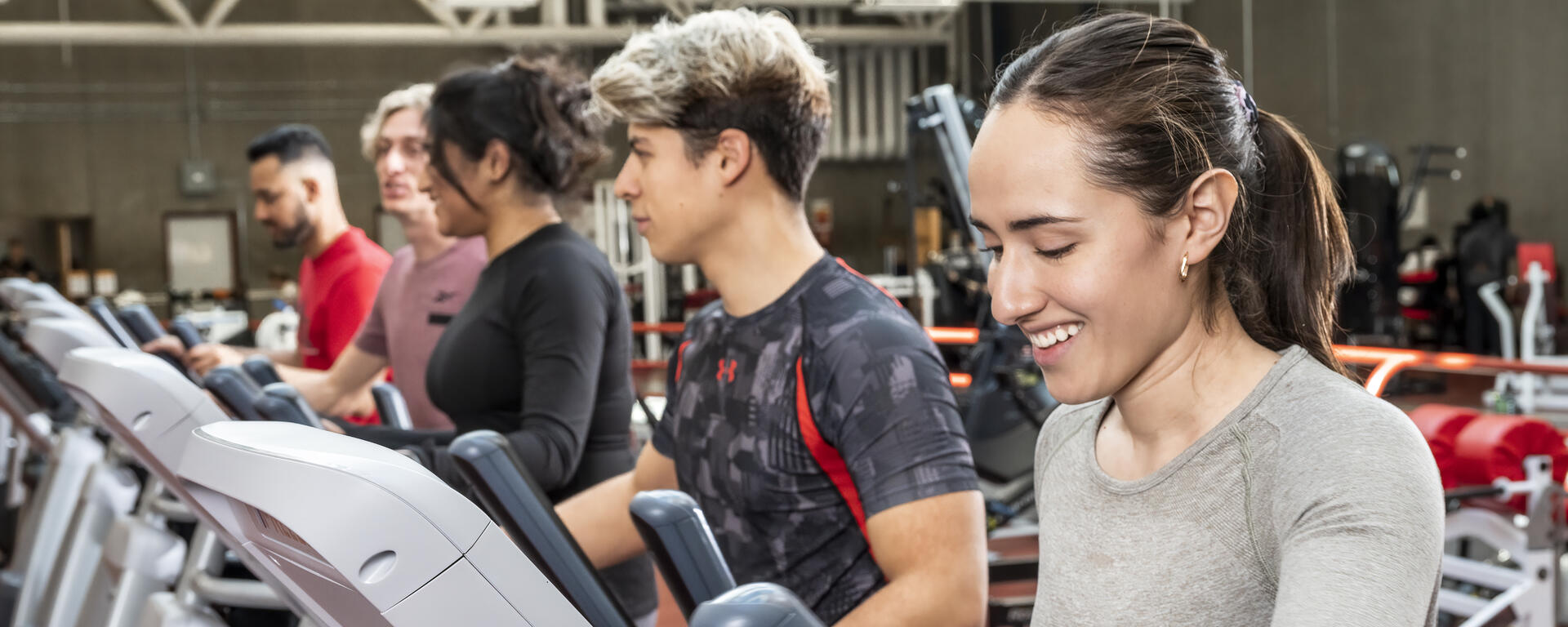 a group of students working out on machines