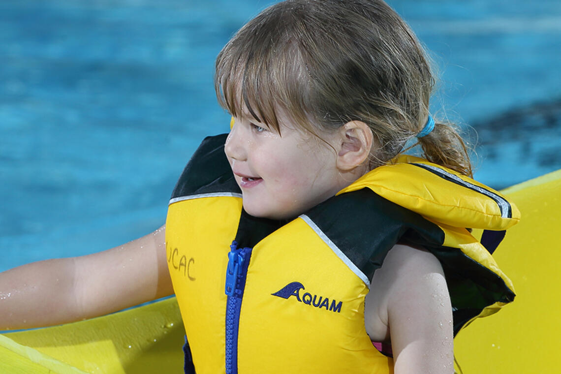 Girl wearing lifejacket in the UCalgary Aquatic Centre