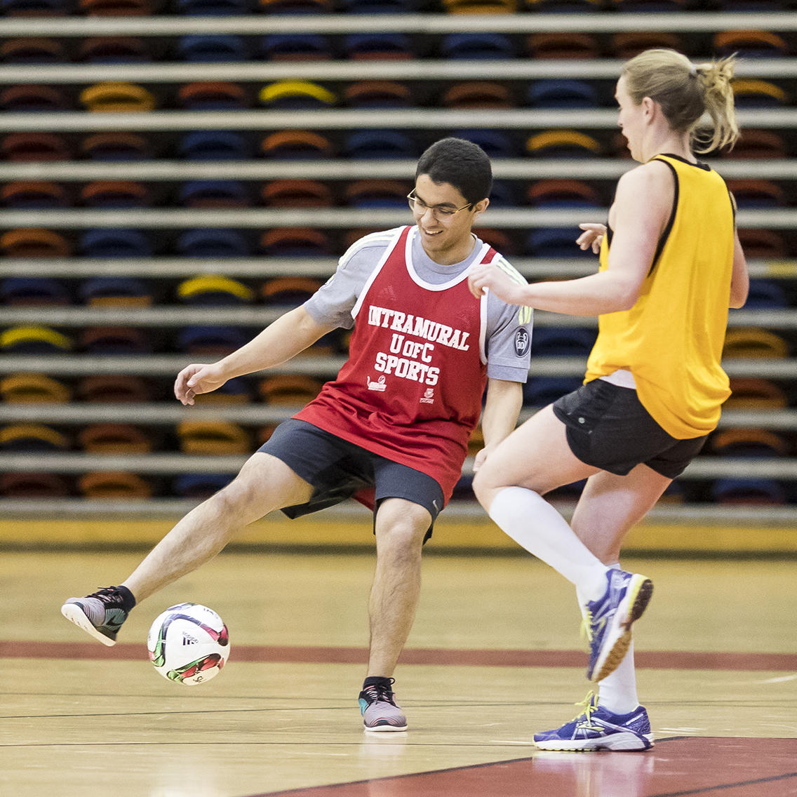 coed-soccer game in a gym