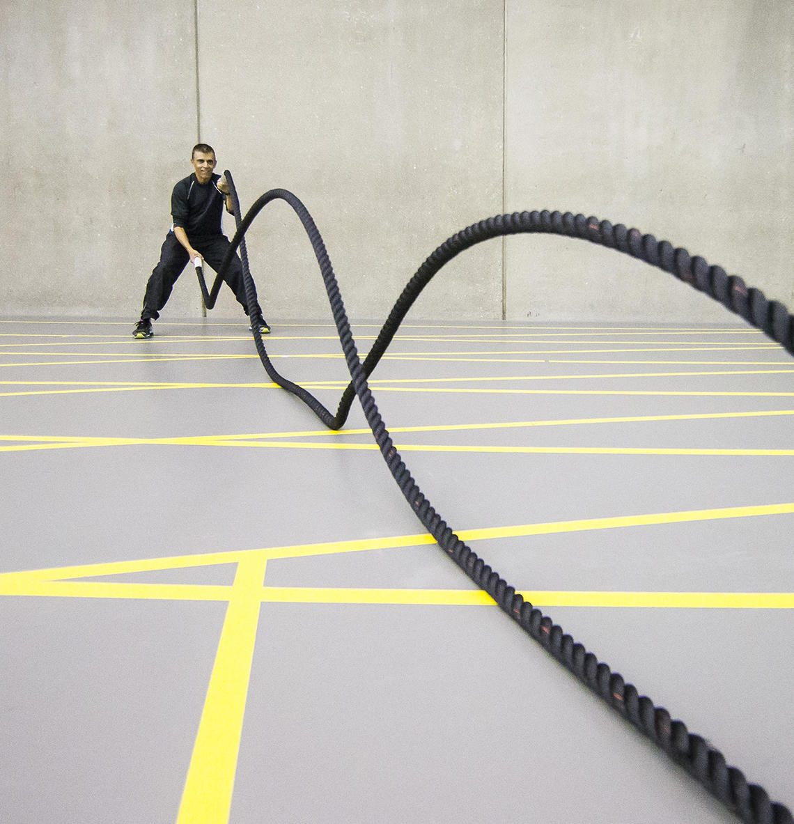 Man working out with battle ropes in Fitness Centre Man working out with battle ropes in Fitness Centre