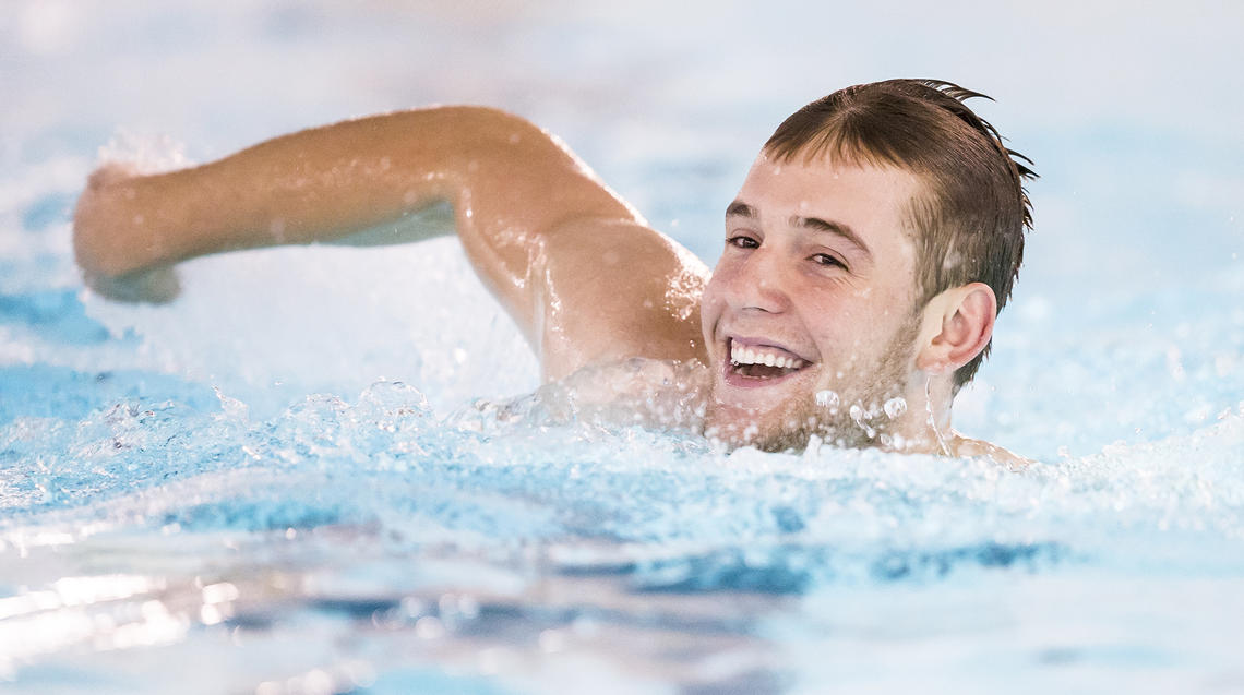 man swimming in UCalgary pool