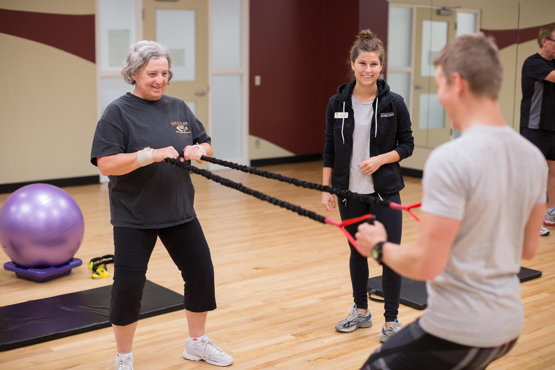 TrymGym client does resistance band workout with a personal trainer