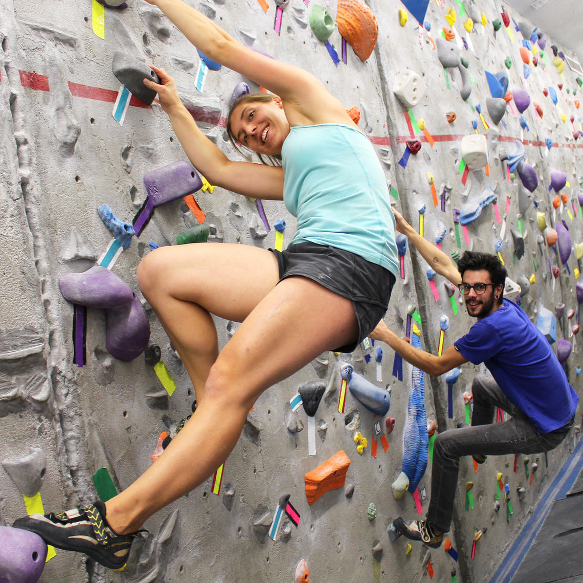 young woman climbing on bouldering wall