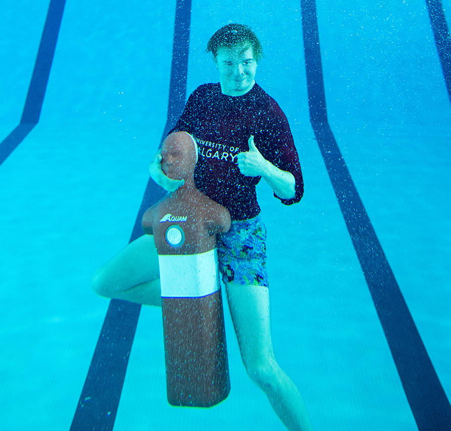 UCalgary lifeguard gives thumbs up under water