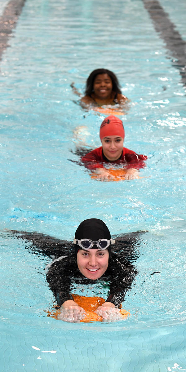 Women at UCalgary Aquatic Centre swimming in lane