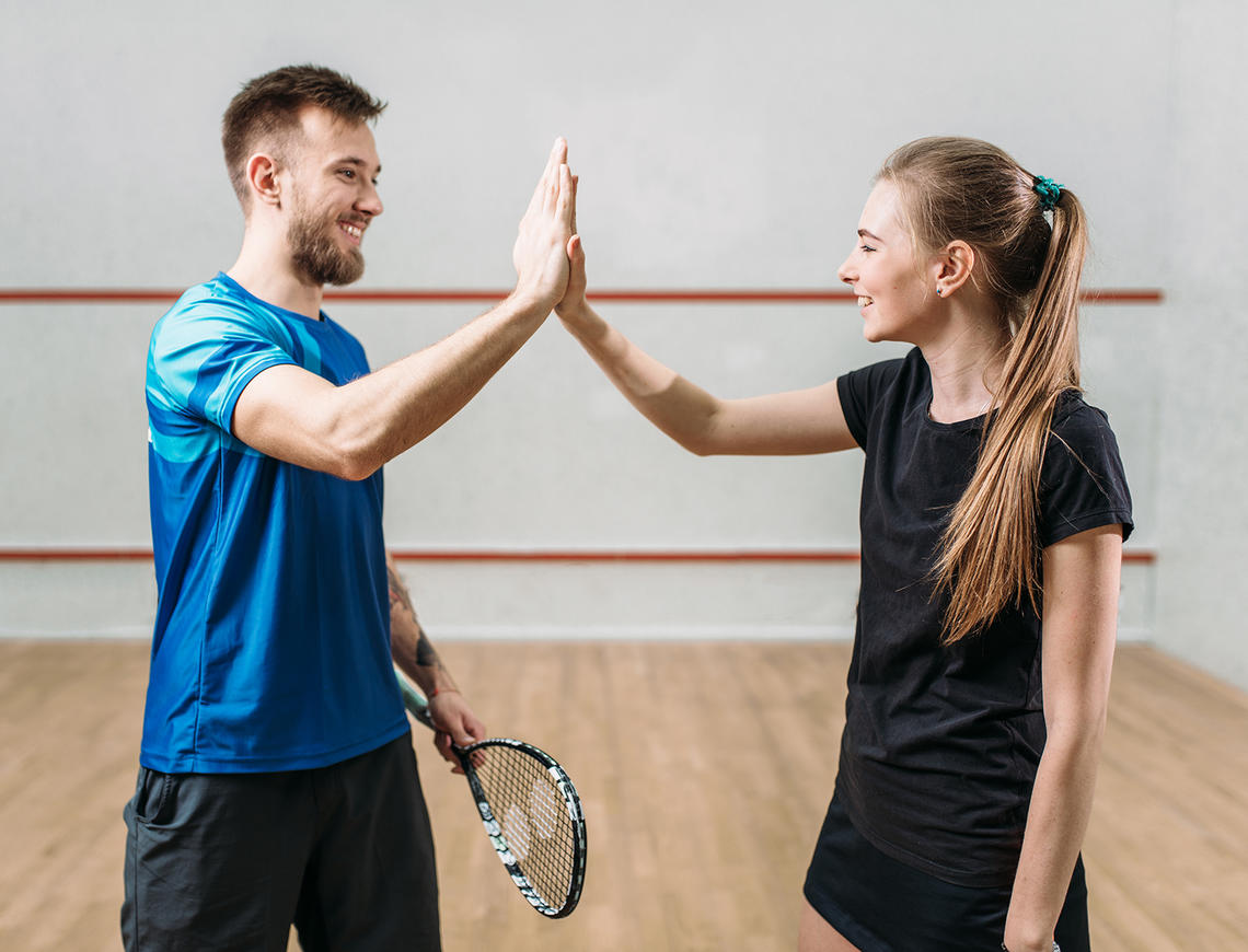 Squash players high five because they love following the rules Squash players high five because they love following the rules