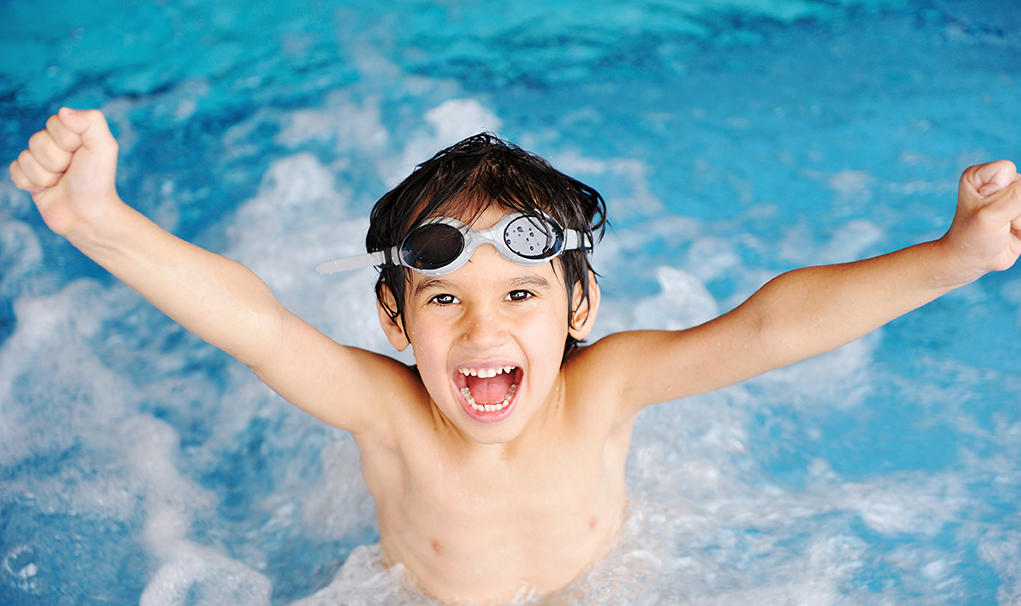 Boy making a splash in the pool