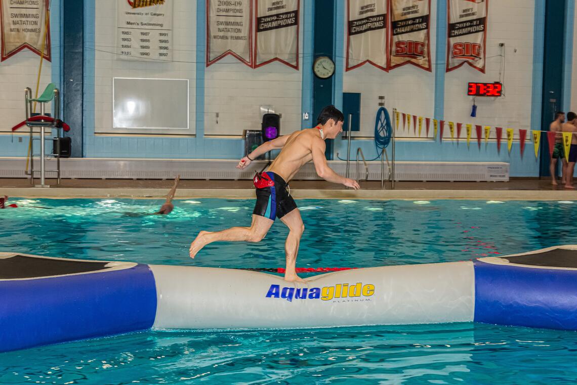A person running across a pool inflatable 