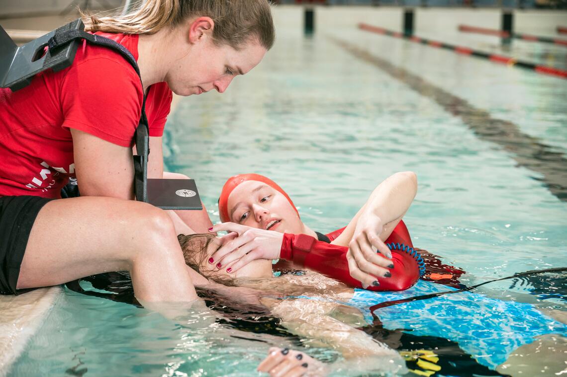Two lifeguards rescuing a swimmer
