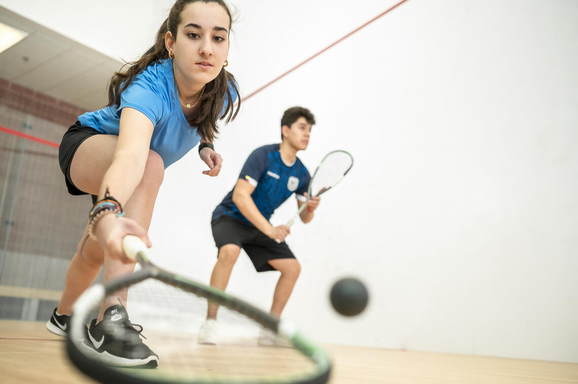 Two people playing racquet ball