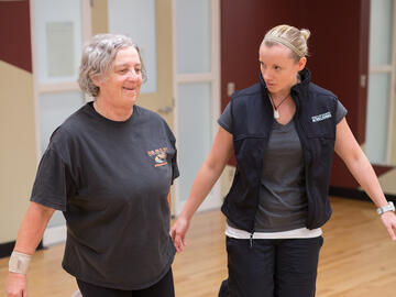 A older women doing exercises with trainer