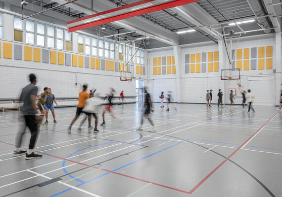 A group of people playing basketball
