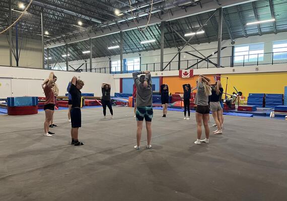A group of adults stretching for gymnastics 