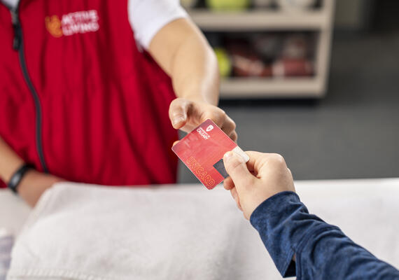 person handing a student card