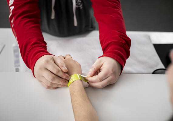a person putting on a wristband
