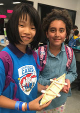 Girls showing their business camp creation