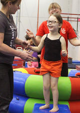 Young girl learning gymnastics at UCalgary