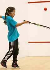 Girl learning how to play racquet sports at UCalgary