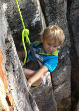 Young boy climbing outdoors