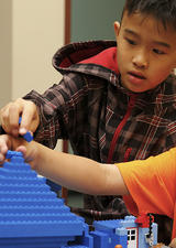 Boys building with lego blocks