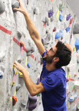 Climber on UCalgary Bouldering Wall